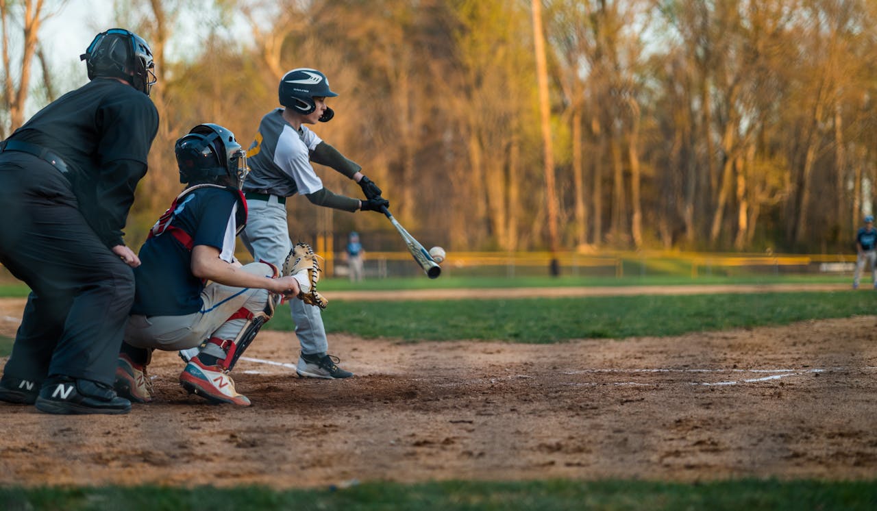 A young baseball player swings at the ball during a game at a local field.