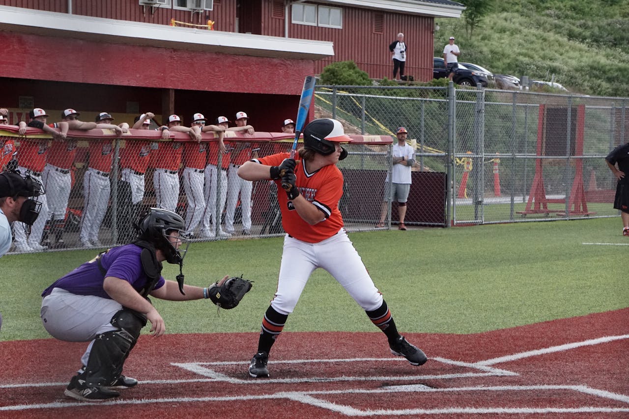 Intense moment in a baseball game with a batter and catcher on the field.